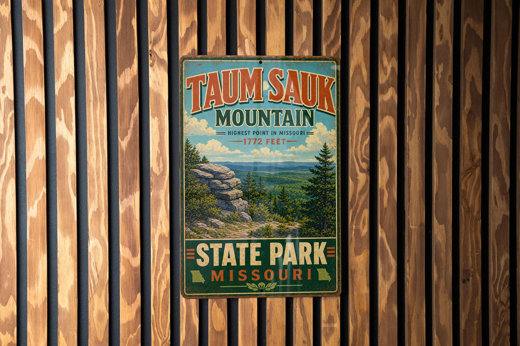 A vintage metal sign for Taun sauk Mountain, the highest point in Missouri, is displayed on a wooden wall.