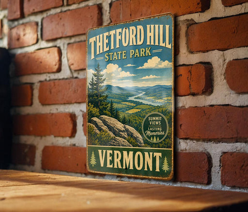 A vintage metal sign for Theftord Hill State Park in Vermont, featuring a scenic mountain landscape.