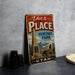 A vintage-style sign for Heritage Park in Utah, featuring a wagon and a monument, is displayed on a gray countertop next to some black camera lenses.