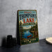 A vintage-style metal sign welcoming visitors to Thompson's Lake State Park in New York.