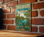 A vintage-style metal sign for Three Rivers State Park in Florida, featuring a scenic illustration of the park's natural and historical attractions.