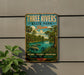 A vintage-style metal sign for Three Rivers State Park in Florida, featuring a tropical landscape with palm trees, a river, and a manatee.