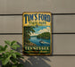 A vintage-style metal sign for Tim's Ford State Park in Tennessee, featuring a scenic image of a lake and a boat.