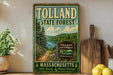 A vintage-style sign for the Tolland State Forest in Massachusetts, featuring a scenic landscape with pine trees, a lake, and mountains.