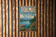 A vintage metal sign for Tolmie State Park in Washington, featuring a scenic mountain landscape and a wooden dock.