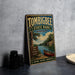 A vintage metal sign for Tombbee State Park in Mississippi, featuring a scenic illustration of a lake, canoe, and forest.