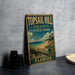 A vintage-style metal sign for Top sail Hill Preserve State Park in Florida, featuring a beach scene and a palm tree.
