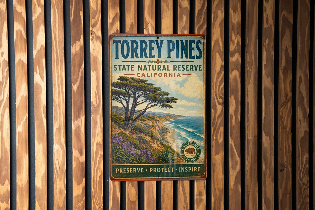 A vintage-style metal sign for Torrey Pines State Natural Reserve in California, featuring a scenic landscape with a pine tree and ocean in the background.