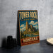 A vintage-style metal sign for Tower Rock State Park in Montana, featuring a scenic mountain landscape.