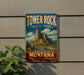 A vintage metal sign for Tower Rock State Park in Montana, featuring a scenic mountain landscape.
