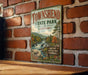 A vintage-style metal sign for Townshend State Park in Vermont, featuring a scenic illustration of a river, forest, and waterfall.