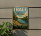A vintage-style metal sign for Trace State Park in Mississippi, featuring a scenic landscape with a river and forest.