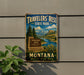 A vintage metal sign for Travelers' Rest State Park in Montana, featuring a scenic landscape with mountains, a river, and a sign that reads "Travelers' Rest State Park Montana".