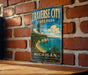 A vintage-style sign for Traverse City State Park in Michigan, featuring a scenic landscape with a beach, cliffs, and a lake.