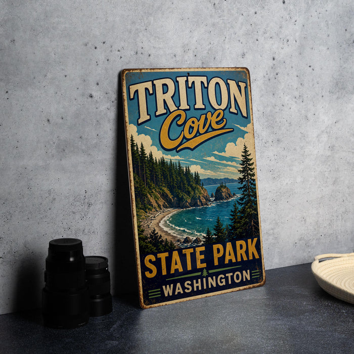 A vintage metal sign for Triton Cove State Park in Washington, featuring a scenic landscape with pine trees, a beach, and a body of water.