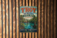 A vintage-style metal sign for Troy Spring State Park in Florida, featuring a scenic illustration of a lake surrounded by palm trees and a cabin.