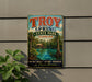 A vintage-style sign for Troy Spring State Park in Florida, featuring a scenic image of the park with a lake and palm trees.