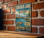 A vintage metal sign for Turlock Lake, California, featuring a scenic illustration of the lake and surrounding landscape.