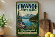 A vintage-style sign for Twanoh State Park, featuring a scenic mountain landscape with a lake and pine trees.