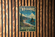A vintage-style sign for Twin Harbors State Park in Washington, featuring a scenic landscape with a beach, mountains, and a river.
