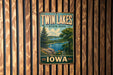 A vintage metal sign for Twin Lakes State Park in Iowa, featuring a scenic landscape with a lake, trees, and mountains.