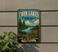 A vintage-style sign for Twin Lakes State Park, featuring a scenic landscape with pine trees, a lake, and mountains in the background.