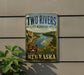 A vintage-style metal sign for the Two Rivers State Recreation Area in Nebraska, featuring a scenic image of a river and mountains.