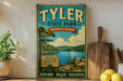 A vintage-style metal sign for Tyler State Park in Pennsylvania, featuring a scenic landscape with a lake and mountains.