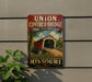 A vintage-style metal sign for the Union Covered Bridge in Missouri, featuring an illustration of a covered bridge with a scenic background.