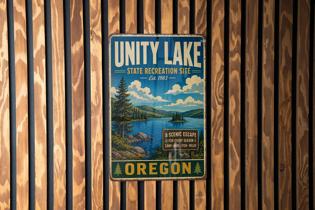 A vintage-style metal sign for the Unity Lake State Recreation Site in Oregon, featuring a scenic landscape with a lake, mountains, and pine trees.