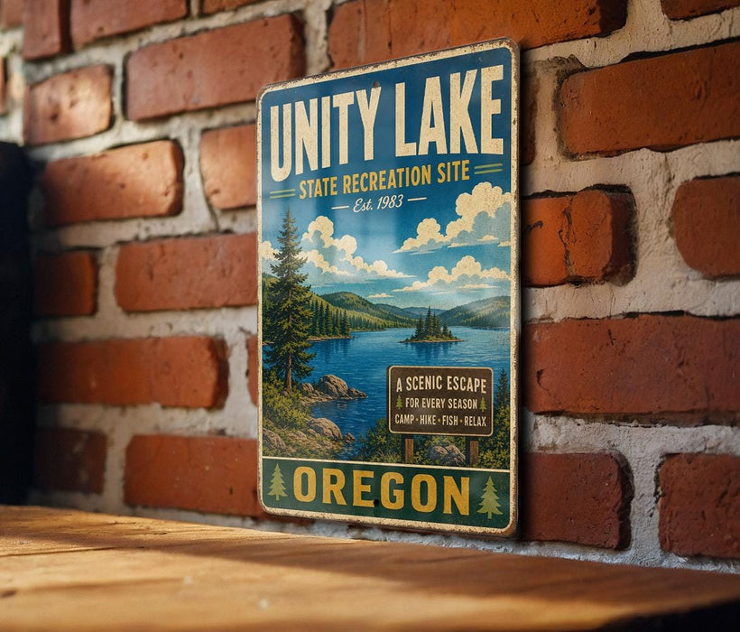 A vintage-style metal sign for the Unity Lake State Recreation Site in Oregon, featuring a scenic landscape with a lake, mountains, and pine trees.