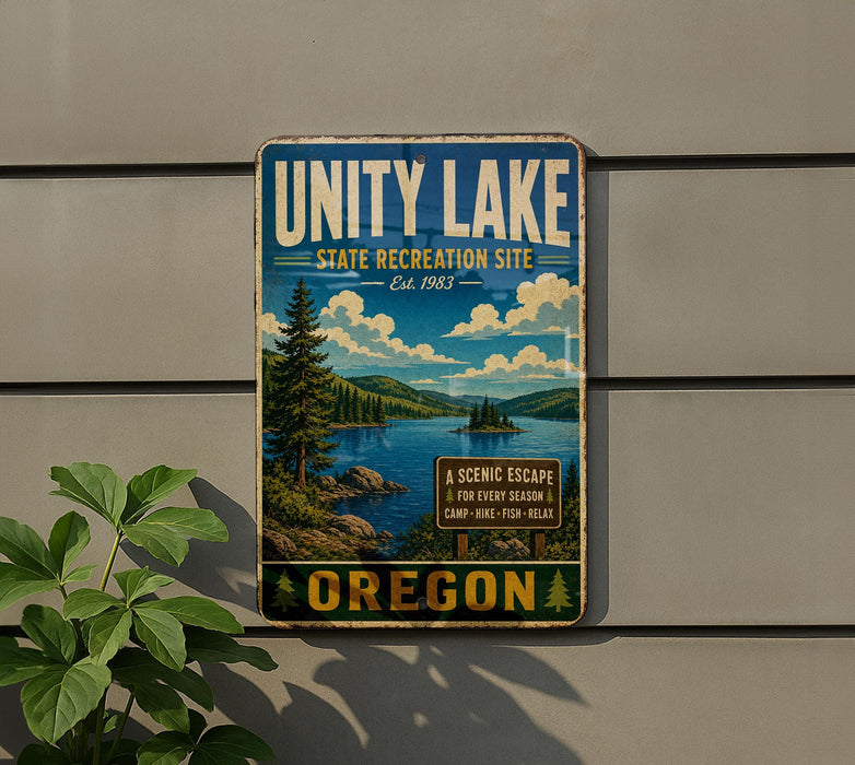 A vintage-style metal sign for the Unity Lake State Recreation Site in Oregon, featuring a scenic landscape with a lake, mountains, and pine trees.