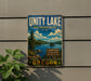 A vintage-style metal sign for the Unity Lake State Recreation Site in Oregon, featuring a scenic landscape with a lake, mountains, and pine trees.