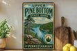 A vintage-style metal sign for Upper Pine Bottom State Park in Pennsylvania, featuring a scenic landscape with pine trees, a river, and mountains.