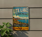 A vintage metal sign for Utah Lake State Park, featuring a scenic landscape with a sailboat on the water.