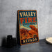 A vintage-style metal sign for Valley of Fire State Park in Nevada, featuring an illustration of the desert landscape.