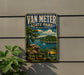 A vintage-style metal sign for Van Meter State Park in Missouri, featuring a scenic landscape with a lake, mountains, and a sailboat.