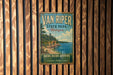 A vintage-style sign for Van Riper State Park in Michigan, featuring a scenic landscape with a lake and mountains.