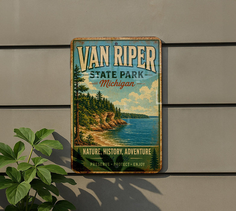 A vintage-style metal sign for Van Riper State Park in Michigan, featuring a scenic landscape with a lake and mountains.