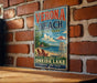 A vintage-style metal sign for Verona Beach State Park, featuring a beach scene with a lifeguard tower and chairs, mounted on a brick wall.