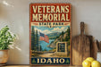 A vintage-style metal sign for the Veterans Memorial State Park in Idaho, featuring an American flag and a scenic landscape.