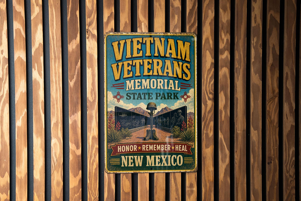 a vintage-style metal sign with the text "Vietnam Veterans Memorial State Park" and "Honor + Remember + Heal New Mexico" displayed on a wooden wall.