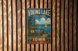 A vintage metal sign for Viking Lake State Park in Iowa, featuring a scenic image of a lake with a sailboat and surrounded by pine trees.