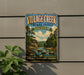 a vintage-style sign for Village Creek State Park in Arkansas, depicting a scenic landscape with a river, trees, and a cloudy sky.