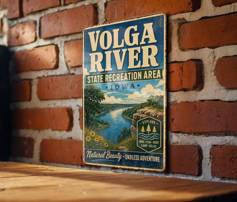 A vintage-style metal sign for the Volga River State Recreation Area in Iowa, featuring a scenic illustration of the river and surrounding landscape.