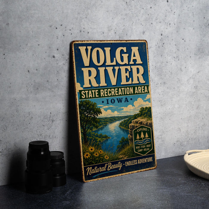 A vintage-style metal sign for the Volga River State Recreation Area in Iowa, featuring a scenic landscape with a river, trees, and mountains.