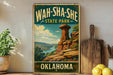 A vintage-style metal sign for Wah-Sha-She State Park in Oklahoma, featuring a scenic landscape with a rock formation and a river.