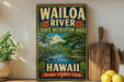 A vintage-style sign for the Waioa River State Recreation Area in Hawaii, featuring a tropical landscape with palm trees, mountains, and a river.