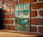 A vintage-style metal sign for Wallace State Park in Missouri, featuring a scenic landscape with a lake and mountains.