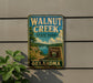 A vintage-style metal sign for Walnut Creek State Park in Oklahoma, featuring a scenic landscape with a lake and mountains.